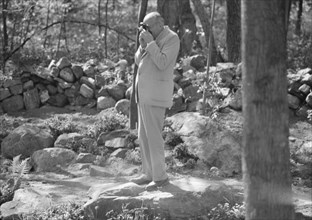 Rothbart, Albert, Mr., taking a photograph outdoors, between 1920 and 1935. Creator: Arnold Genthe.