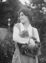 Savagoy, Henriette, with cat, outdoors, 1922 July 31. Creator: Arnold Genthe.