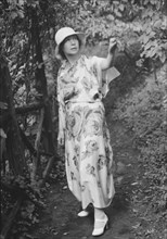 Stettheimer, Florine, Miss, standing outdoors, 1931 Aug. 19. Creator: Arnold Genthe.