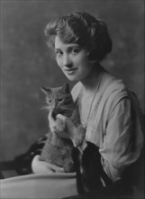 Bainter, Fay, Miss, with Buzzer the cat, portrait photograph, 1916. Creator: Arnold Genthe.