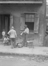 Street vendor, New Orleans, between 1920 and 1926. Creator: Arnold Genthe.