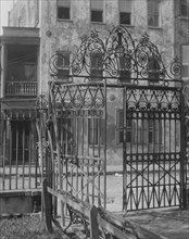 Park gate and houses, [36 Chalmers Street through Washington Park Gate], Charleston..., c1920-c1926. Creator: Arnold Genthe.