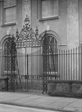 Unidentified building behind a fence, New Orleans or Charleston, South Carolina, c1920-1926. Creator: Arnold Genthe.