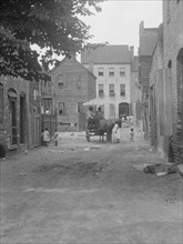 Street scene - looking north on Bedons Alley to Elliott Street; with horse and wagon..., c1920-1926. Creator: Arnold Genthe.