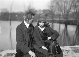 Arnold Genthe seated outdoors with a woman friend, between 1896 and 1942. Creator: Arnold Genthe.
