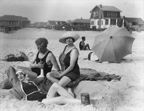 Arnold Genthe with two women friends in Long Beach, New York, between 1911 and 1942. Creator: Arnold Genthe.