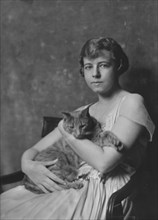 Miss Marjorie Cluett, with Buzzer the cat, portrait photograph, 1917 Dec. Creator: Arnold Genthe.
