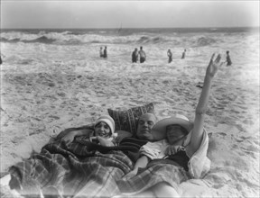 Unidentified man and two women at Long Beach, New York, between 1911 and 1942. Creator: Arnold Genthe.