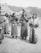 Ainu woman outside in the village lane, 1908. Creator: Arnold Genthe.