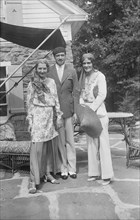 Pierre de Beaumont and two unidentified women, standing outdoors, between 1932 and 1942. Creator: Arnold Genthe.