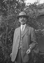 Unidentified man, standing outdoors, between 1896 and 1942. Creator: Arnold Genthe.