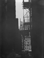 View between buildings of Mather Building/Tower in distance. Chicago, Illinois, c1896-c1942. Creator: Arnold Genthe.