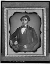 Unidentified man, three-quarter length portrait, full face, with arm on..., between 1849 and 1860. Creator: Unknown.