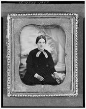Unidentified woman, three-quarter length portrait, facing front, seated..., between 1840 and 1860. Creator: Unknown.