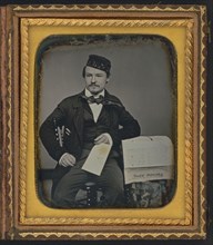 Portrait of seated man holding the Charleston Zeitung, possibly the owner of the newspaper..., 1853. Creator: Unknown.