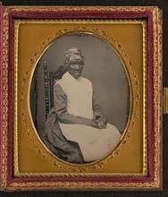 Unidentified African American woman in headscarf and apron, between 1850 and 1870. Creator: Unknown.