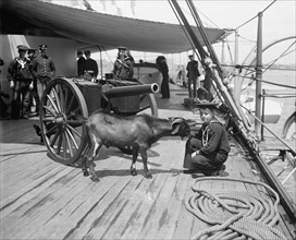 U.S.S. New York, Admiral Sampson's son and "Pitch" the mascot, (1899?). Creator: Unknown.