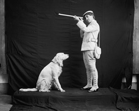 Billy and his mistress in hunting poses, between 1895 and 1910. Creator: Unknown.