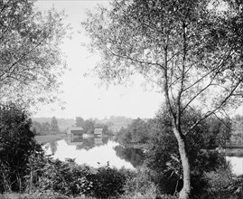 Buildings by river, probably the Huron River, Ypsilanti, Michigan, between 1900 and 1910. Creator: Unknown.