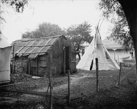 Hut and tepee, probably St. Clair Flats, Mich., between 1900 and 1920. Creator: Unknown.