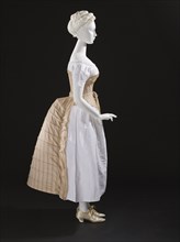 Woman's bustle, England, c.1885. Corset: c.1865-75, Chemise: c.1850-70, Shoes: 1875-1900. Creator: Unknown.