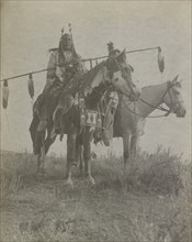 Village criers on horseback, Bird On the Ground and Forked Iron, Crow Indians, Montana, c1908. Creator: Edward Sheriff Curtis.