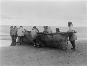 Launching the whale boat-Cape Prince of Wales, c1929. Creator: Edward Sheriff Curtis.