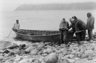 Launching the boat-Little Diomede Island, c1928. Creator: Edward Sheriff Curtis.