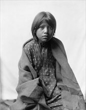 A Taos girl, three-quarter length portrait, seated, facing front, c1905. Creator: Edward Sheriff Curtis.