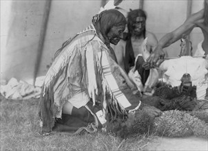 Saliva, Slow Bull (in background), Picket Pin's arm, c1907. Creator: Edward Sheriff Curtis.