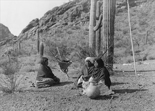 Qahatika women resting in Harvest Field-Qahatika, c1907. Creator: Edward Sheriff Curtis.