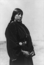 Arapaho maiden, three-quarter-length portrait, standing, facing right, c1910. Creator: Edward Sheriff Curtis.