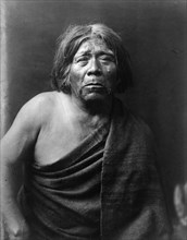 Mat Stams-Maricopa, half-length portrait, facing front, wrapped in blanket, c1907. Creator: Edward Sheriff Curtis.