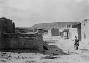 A street scene in San Ildefonso Pueblo, 1905, c1905. Creator: Edward Sheriff Curtis.