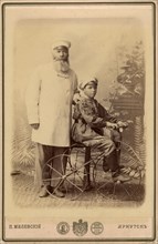 Portrait of an unknown man with a boy sitting on a bicycle, end of 19th century. Creator: PA Milevskii.