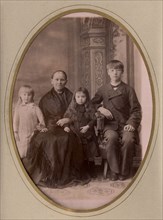 An elderly woman, a young man in a civilian suit and two.,, late 19th cent - early 20th cent. Creator: PA Milevskii.