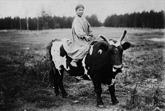 A girl riding a bull, 1890. Creator: Unknown.