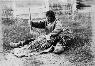 Hammering the sheaf, 1890.  Creator: Unknown.
