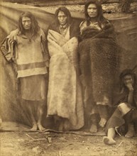 Group of Native Americans, three standing, one seated on the ground, possibly..., 1860 or 1861. Creator: Unknown.