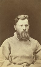 Half-length portrait of a man, dressed in convict clothing, facing right, between 1880 and 1886. Creator: Unknown.