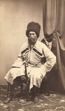 Full-length portrait of Transcaucasian man, seated, facing front, between 1870 and 1886. Creator: Unknown.