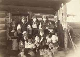 Tatar women with children seated in front of their home, between 1885 and 1886. Creator: Unknown.