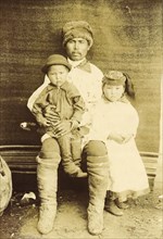 A Kachin Individual (over 30 Years Old). Tanzybaev with Children. Village of Ust'-Abakan, 1894. Creator: Unknown.