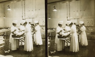 Japanese nurses attending to a patient in an operating room, c1905. Creator: Underwood & Underwood.