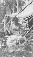 Woman making snow shoes, between c1900 and c1930. Creator: Unknown.