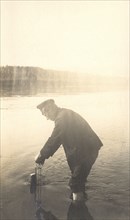 The moment of measuring the water level at the Inorogda hydrometric station, 1909. Creator: Vladimir Ivanovich Fedorov.