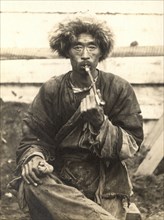 Manchu smoking a pipe, 1909. Creator: Vladimir Ivanovich Fedorov.