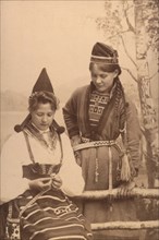 Studio portrait: two women in national costume, 1906.  Creator: Helene Edlund.