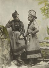 Studio portrait:Two young Sami women dressed in black, 1890-1899. Creator: Helene Edlund.