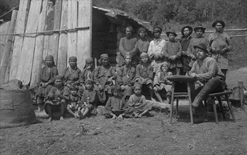 Inhabitants of One Gornaia Shoria Village and an Expedition Member, 1913. Creator: GI Ivanov.